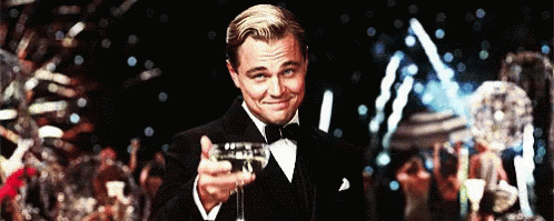 Leonardo Dicaprio raising his glass in front of fireworks